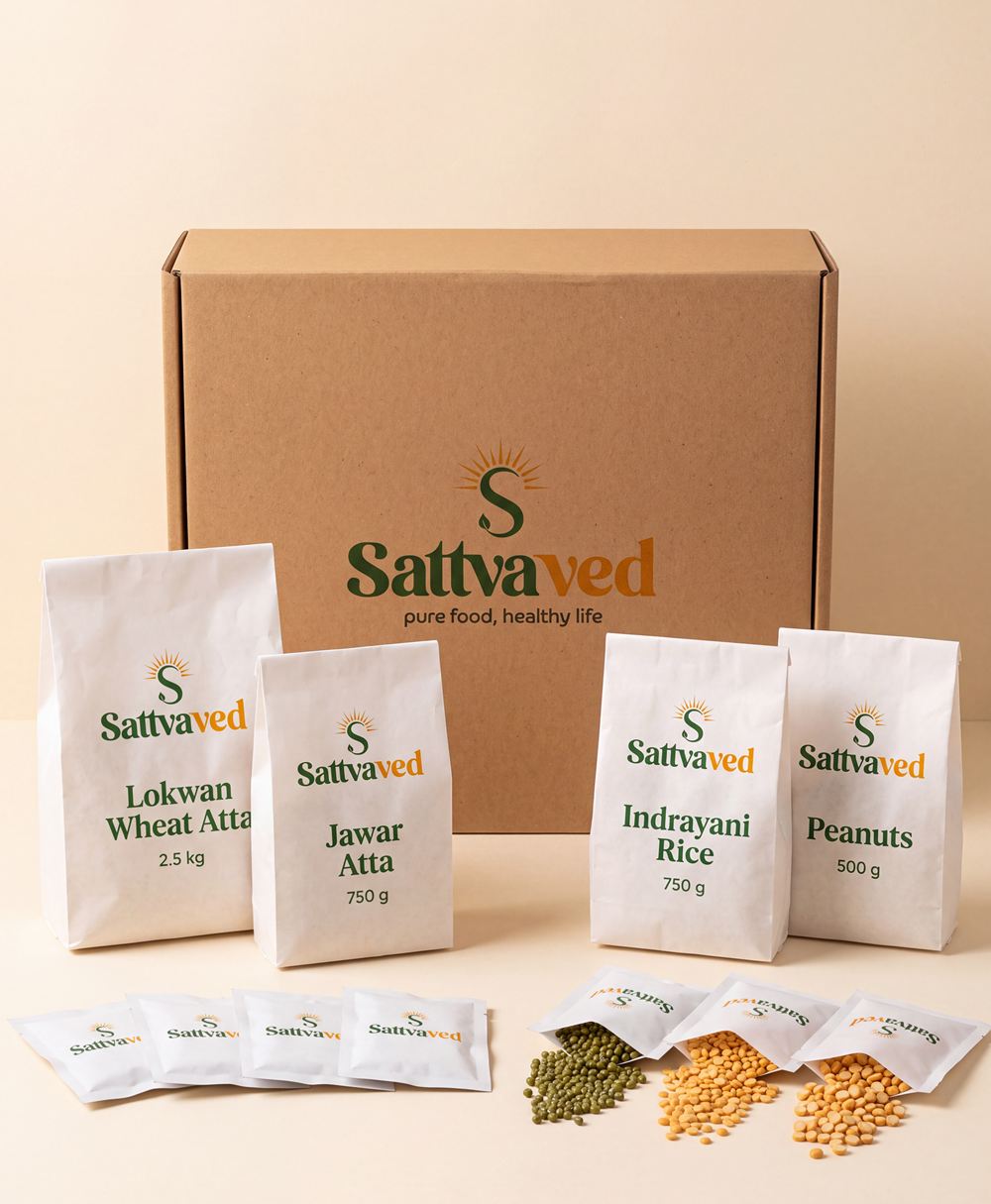 The Sattvaved weekly kit — kraft box with labelled paper packets of atta, rice, peanuts and dal sachets